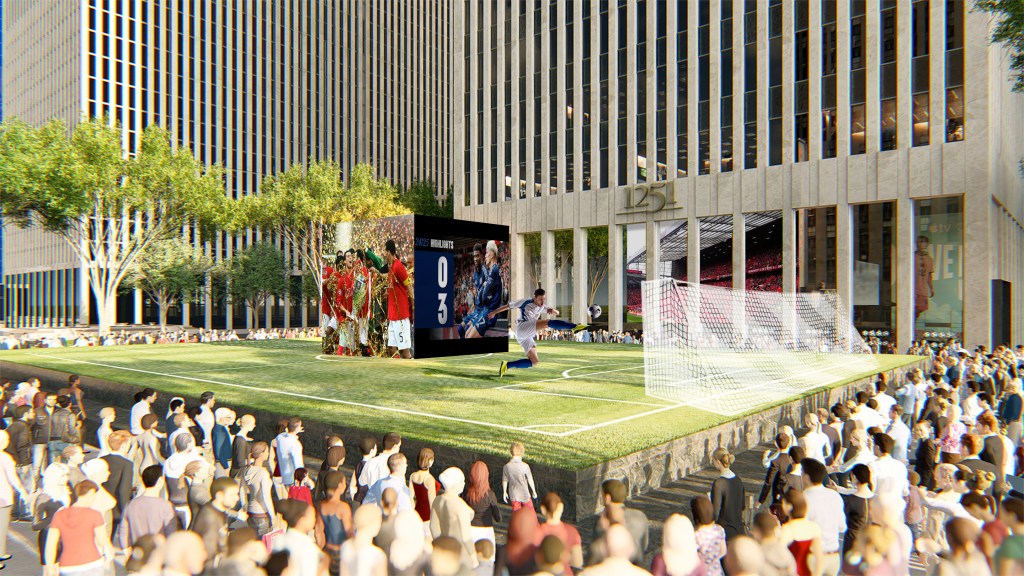 Orlando Enrique Berrío, David Perron and Mikaël Silvestre playing soccer on a field that is part of the layout of 6th Avenue 1251, with a crowd watching.